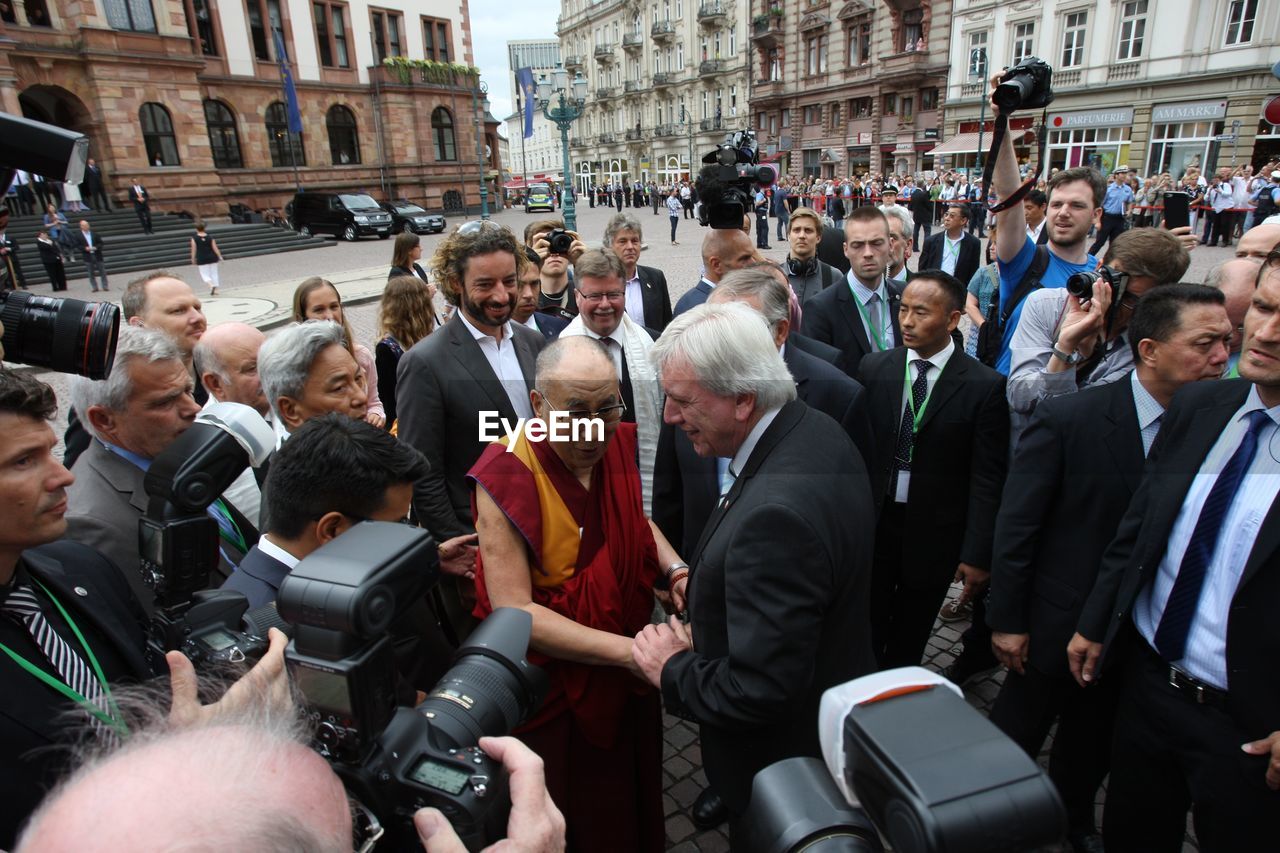 PEOPLE LOOKING AT CITY STREET