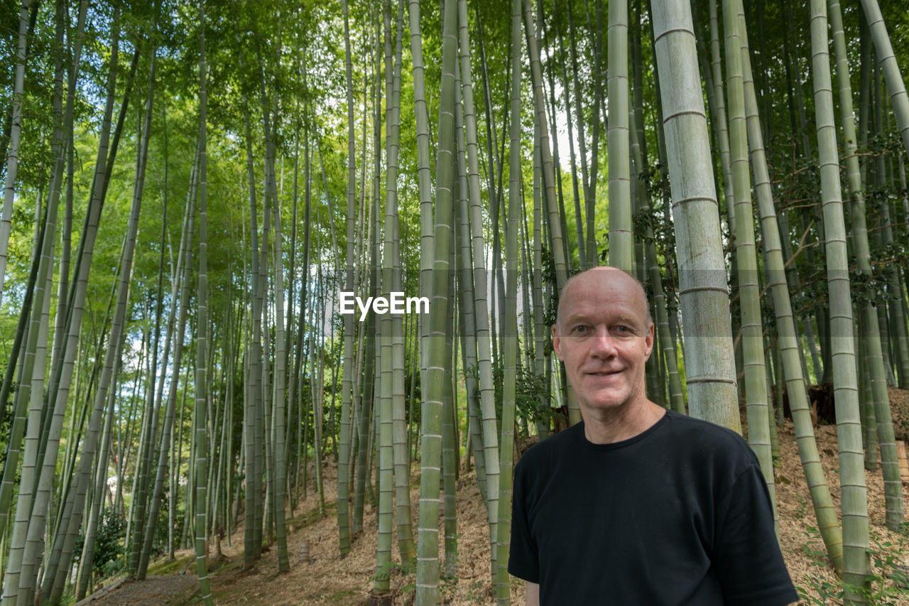 Portrait of smiling young man in forest