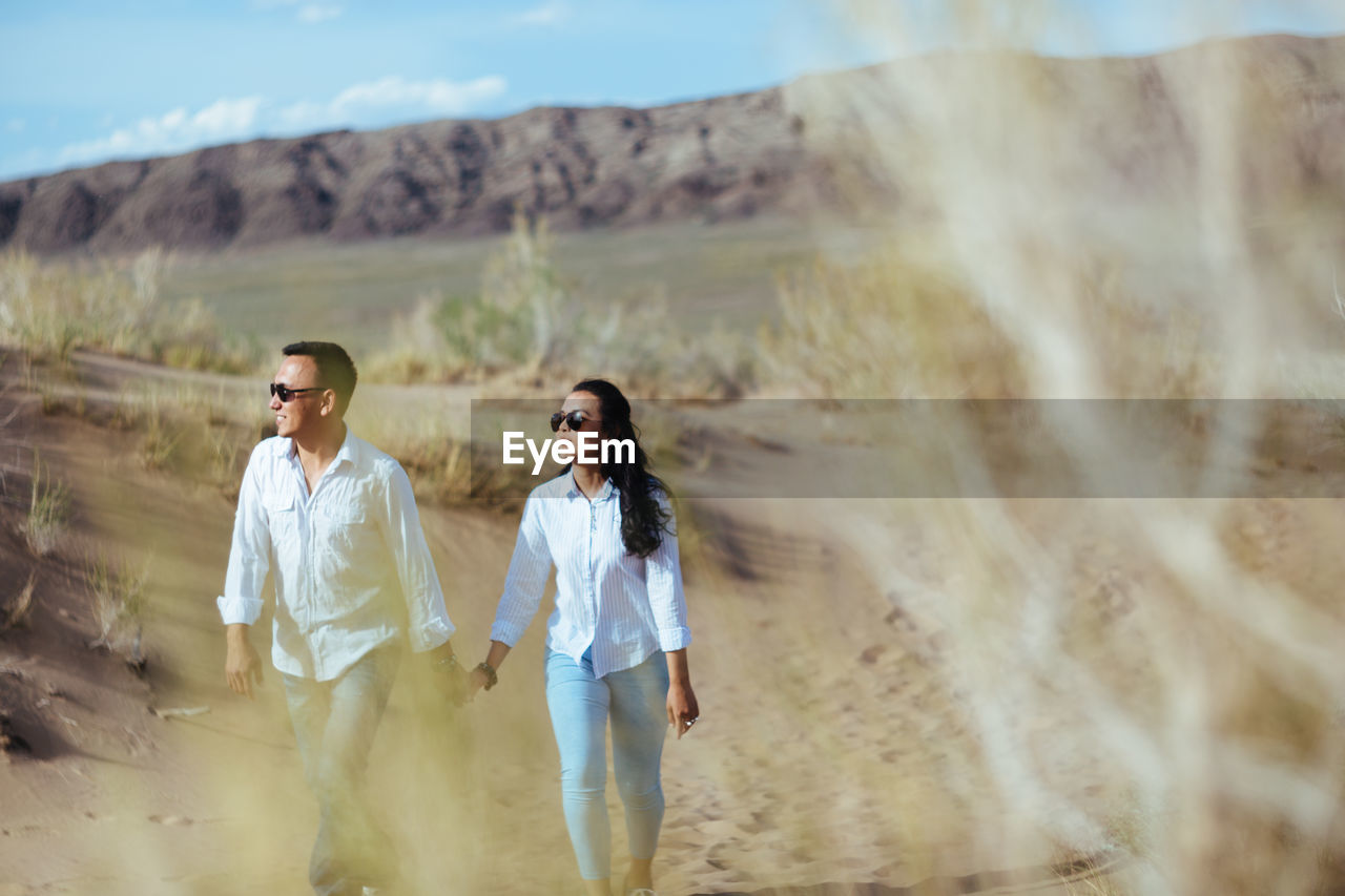 Couple walking on top of mountain landscape