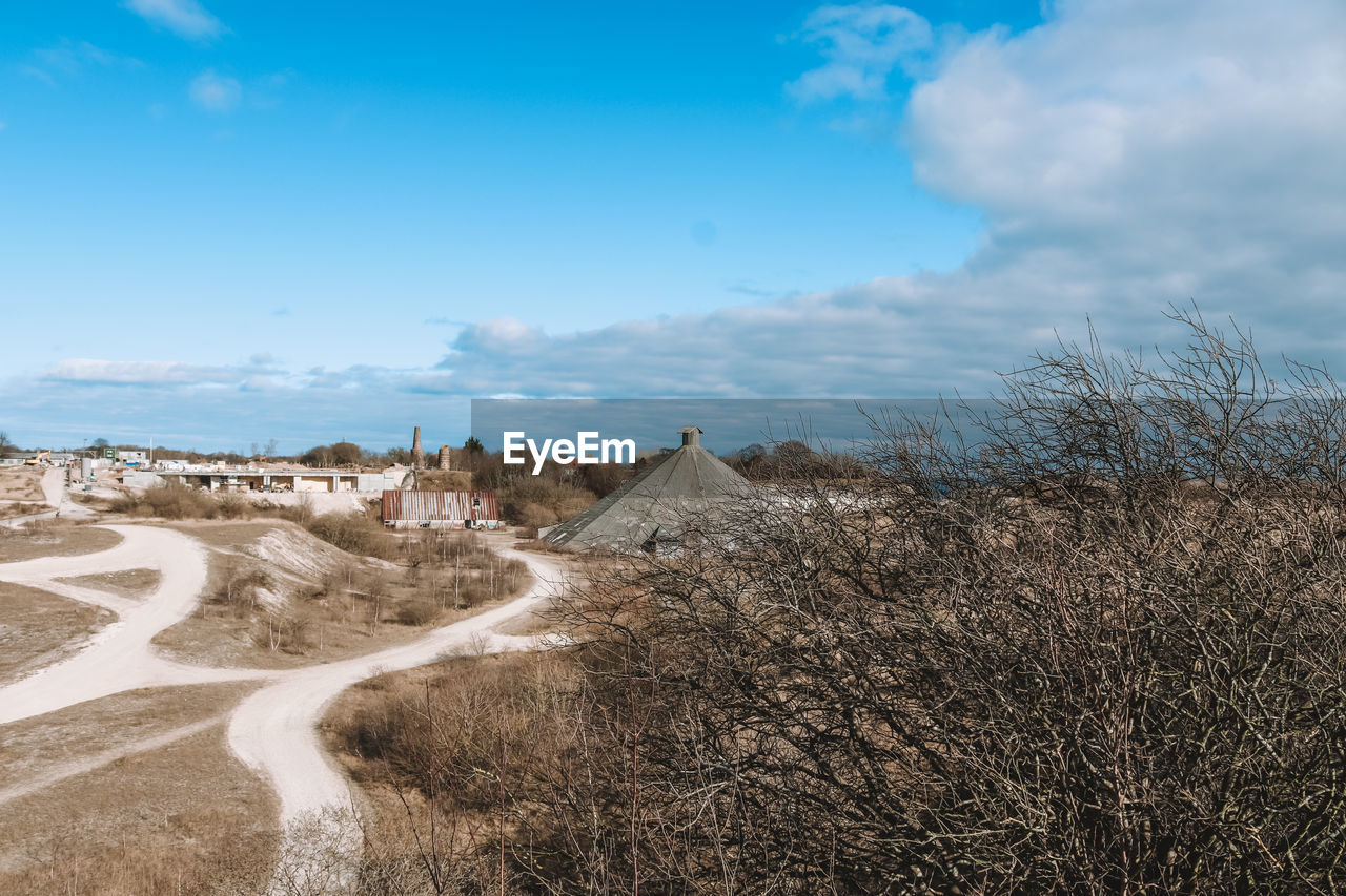 sky, cloud, land, natural environment, landscape, nature, environment, sea, scenics - nature, sand, coast, horizon, travel, plant, no people, blue, beauty in nature, travel destinations, water, outdoors, tourism, tranquility, day, hill, non-urban scene, shore, beach, plateau, tranquil scene, sand dune, road, grass, desert, tree