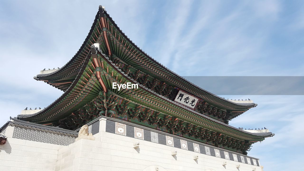 LOW ANGLE VIEW OF TEMPLE AGAINST BUILDING