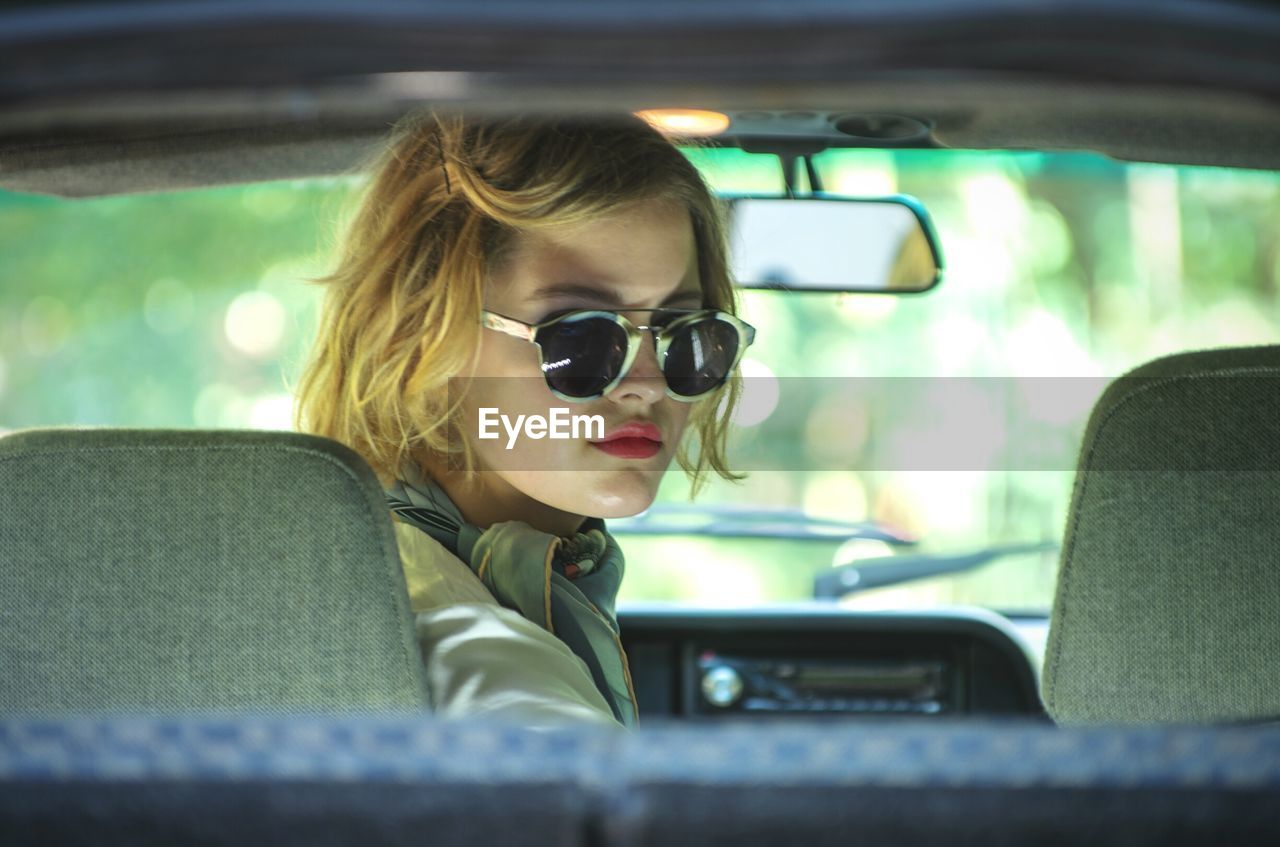 Portrait of woman sitting in car