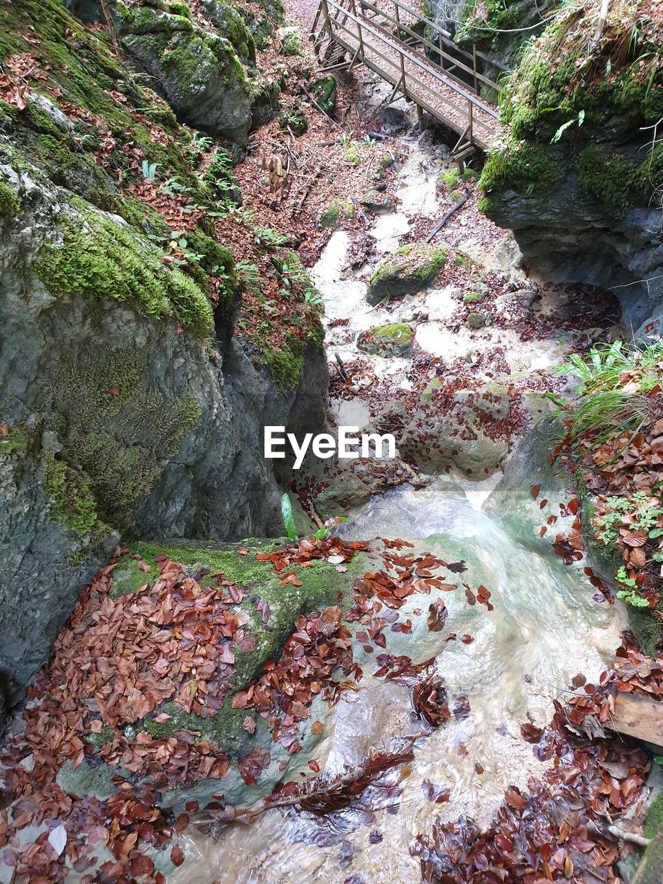 HIGH ANGLE VIEW OF STREAM FLOWING THROUGH ROCKS