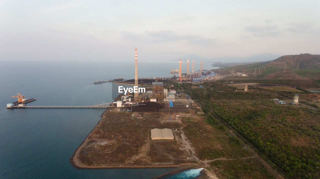 Aerial view power station on the sea coast, jawa island. larger industrial power plant in indonesia.