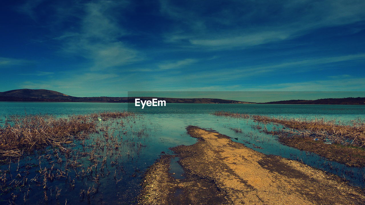 Scenic view of sea against blue sky