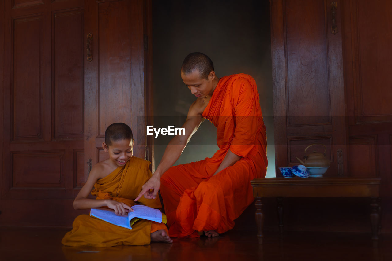 Monk teaching boy in monastery