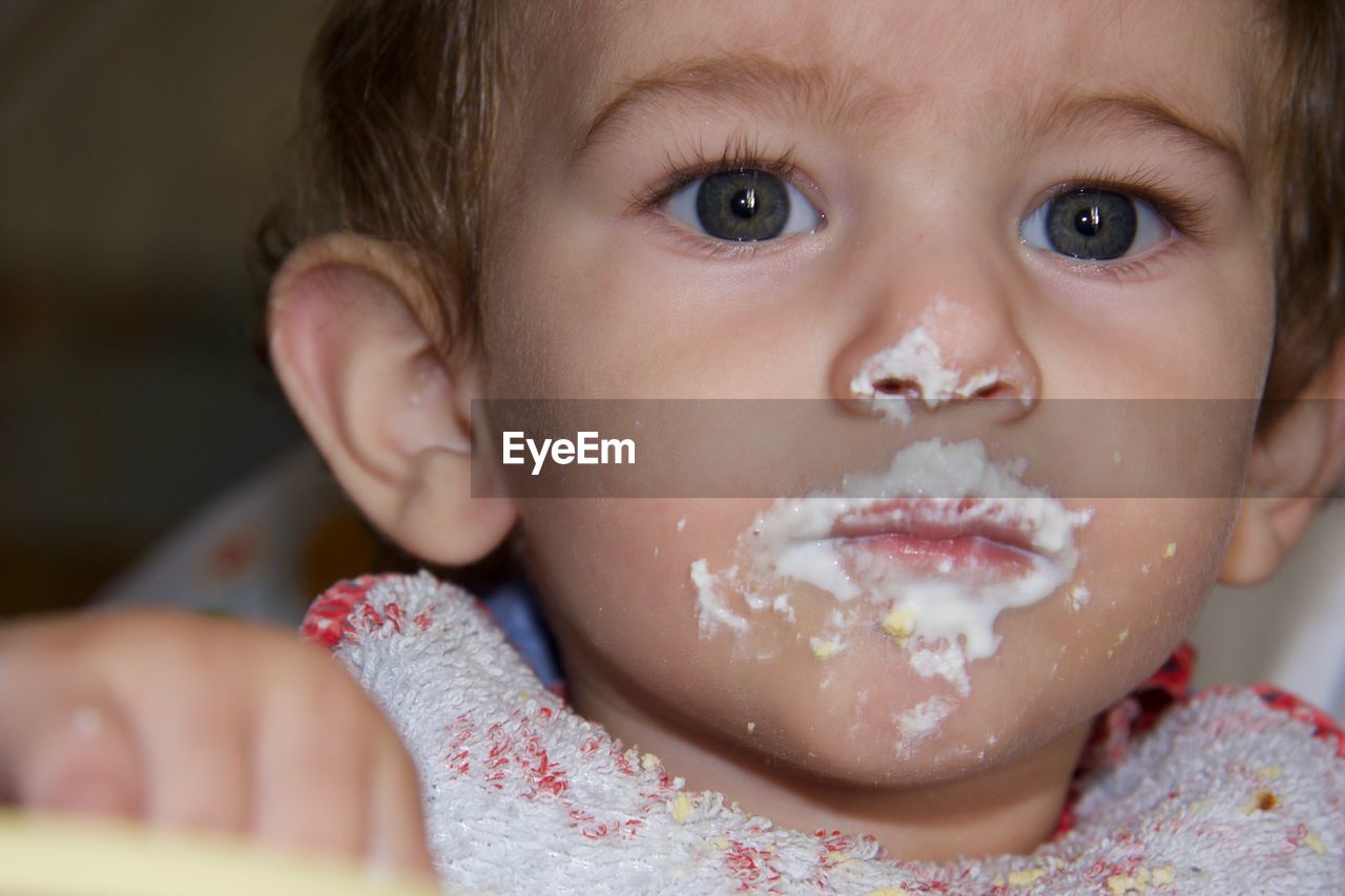 Portrait of cute baby girl with messy mouth