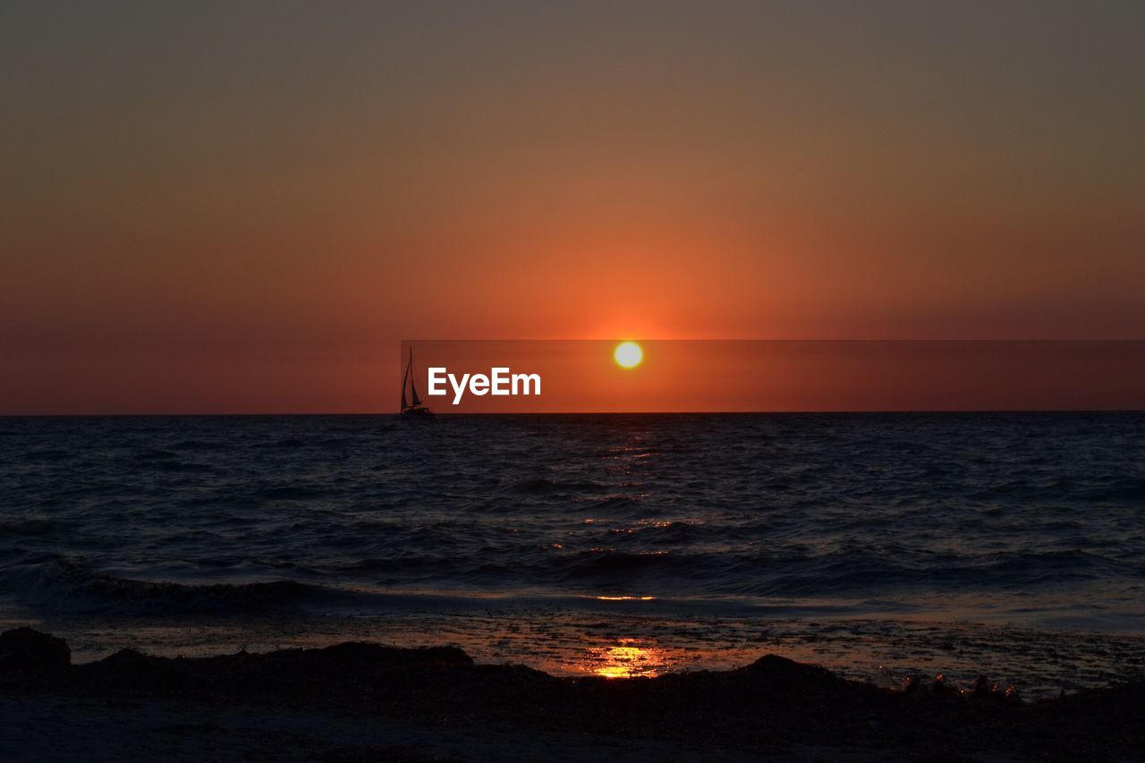 SCENIC VIEW OF SEA AGAINST ORANGE SKY