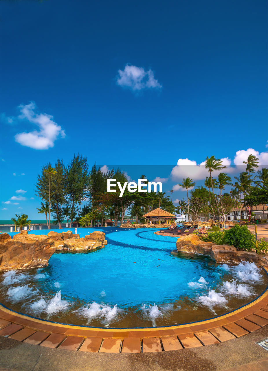 SCENIC VIEW OF SWIMMING POOL AGAINST BLUE SKY