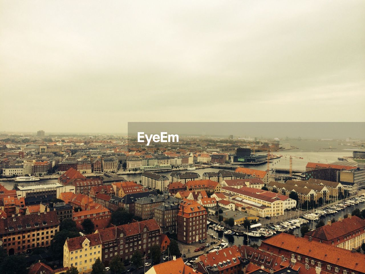 High angle view of cityscape against cloudy sky