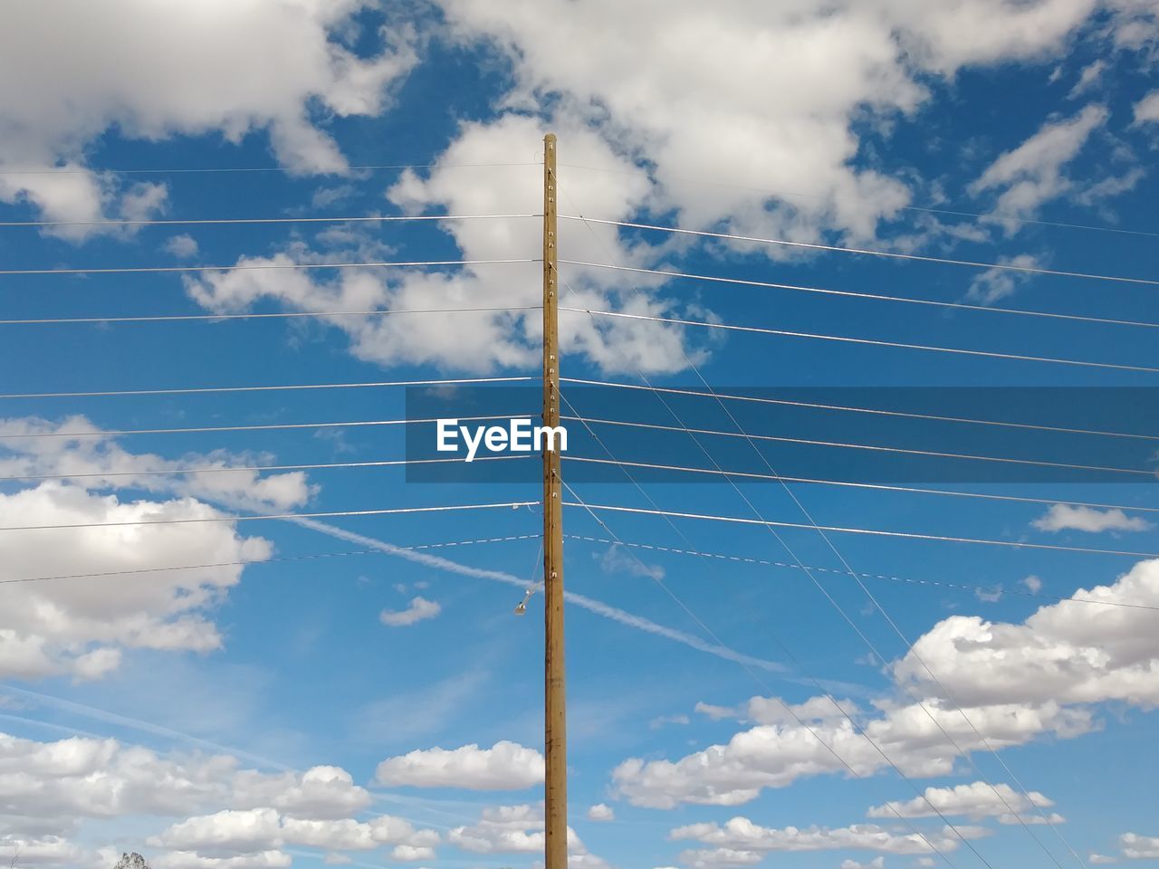 Low angle view of cables against blue sky