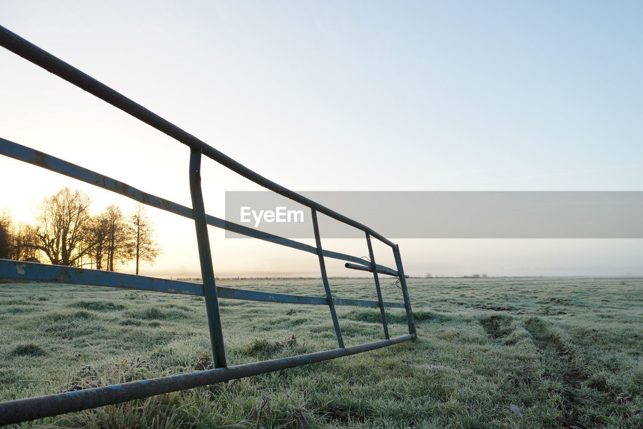 VIEW OF FIELD AGAINST CLEAR SKY