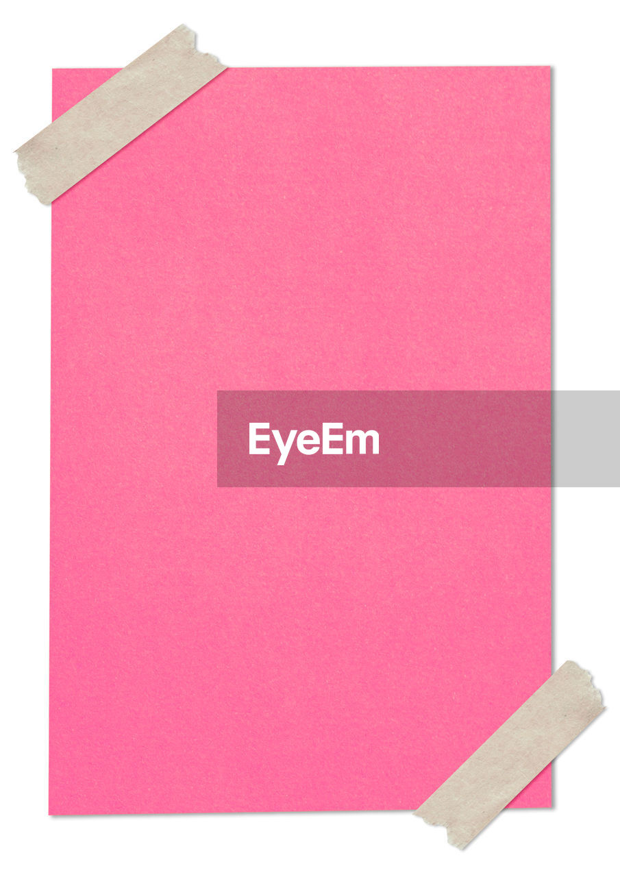 Directly above shot of pink blank paper over white background