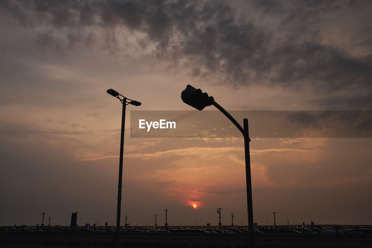 Low angle view of silhouette street light against sky during sunset