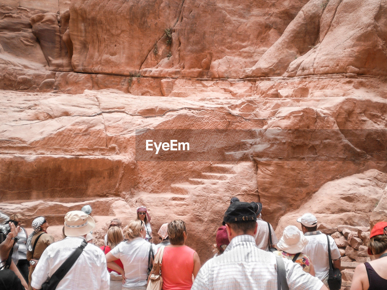 group of people, rock, wadi, rock formation, large group of people, travel destinations, travel, men, nature, canyon, crowd, geology, physical geography, adult, women, tourism, formation, day, lifestyles, outdoors, desert, leisure activity, religion, rear view, mountain, land, ancient history