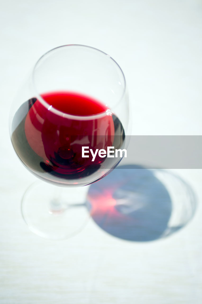 Close-up of red wine over white background