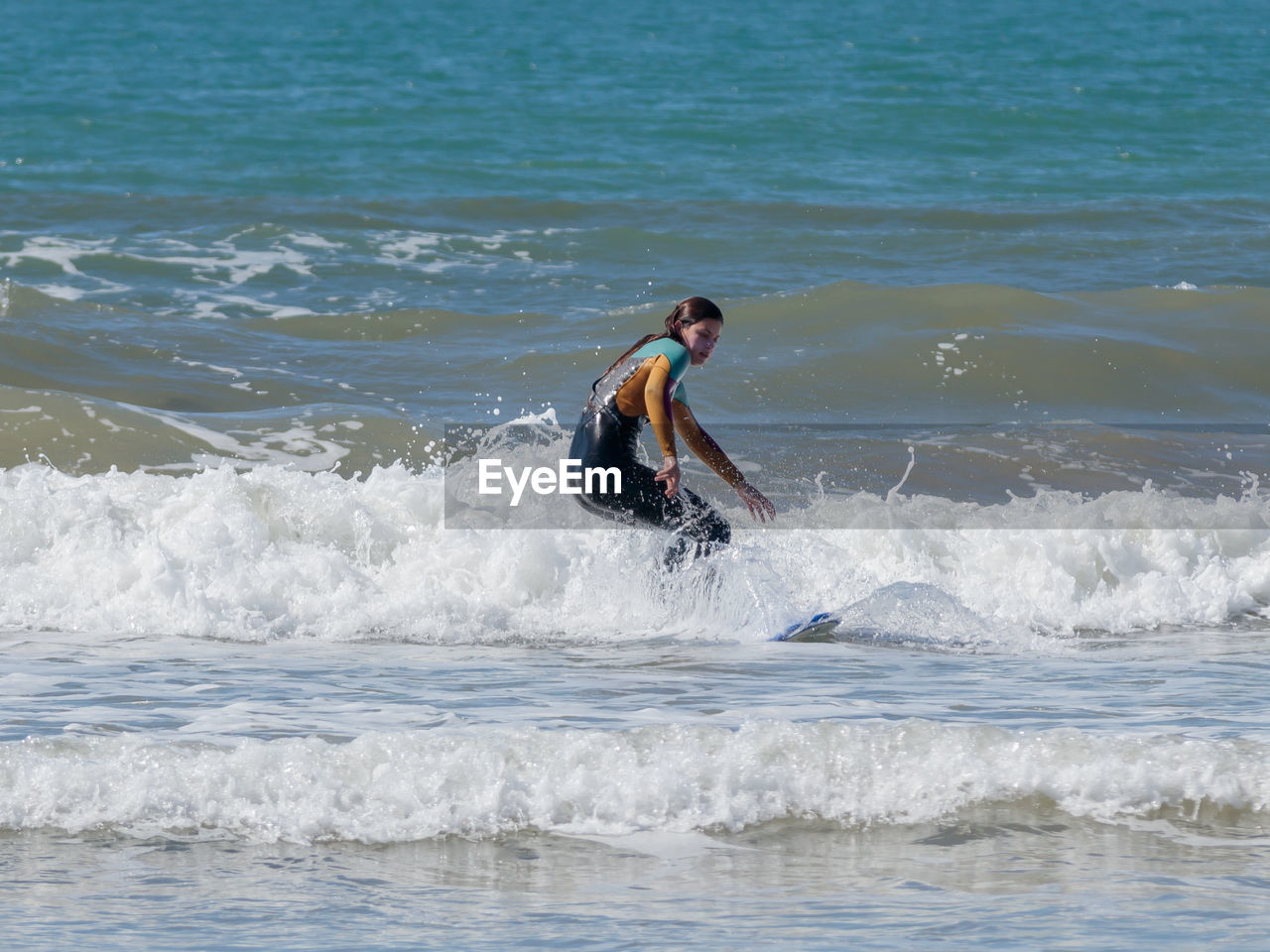 FULL LENGTH OF MAN SURFING