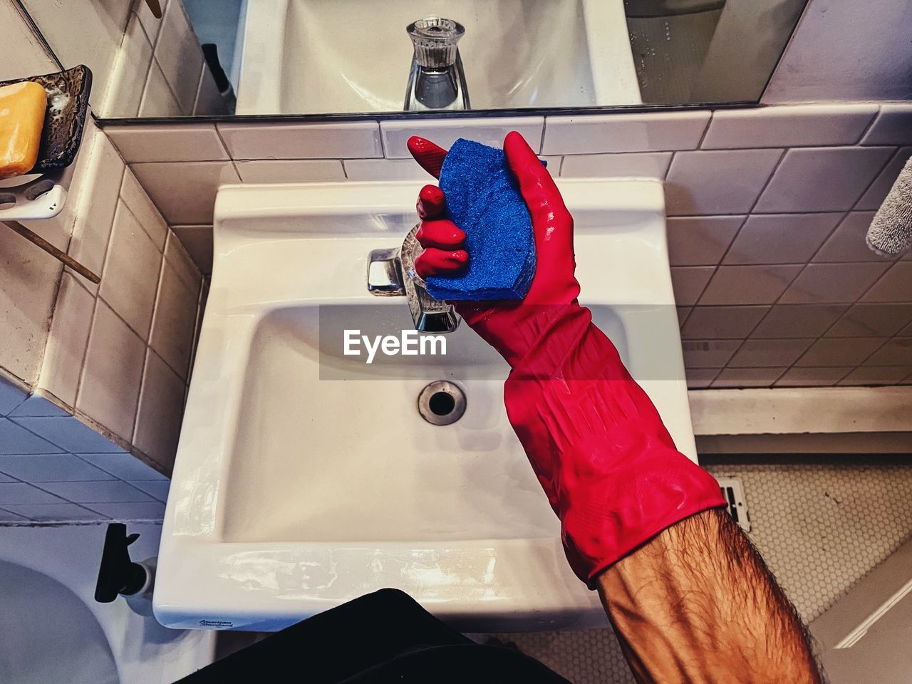 sink, bathroom, plumbing fixture, domestic room, red, tap, indoors, cleaning, household equipment, home, hygiene, one person, protective glove, domestic bathroom, washing, faucet, lifestyles, toilet, domestic life, adult, housework, bathtub, washing up glove