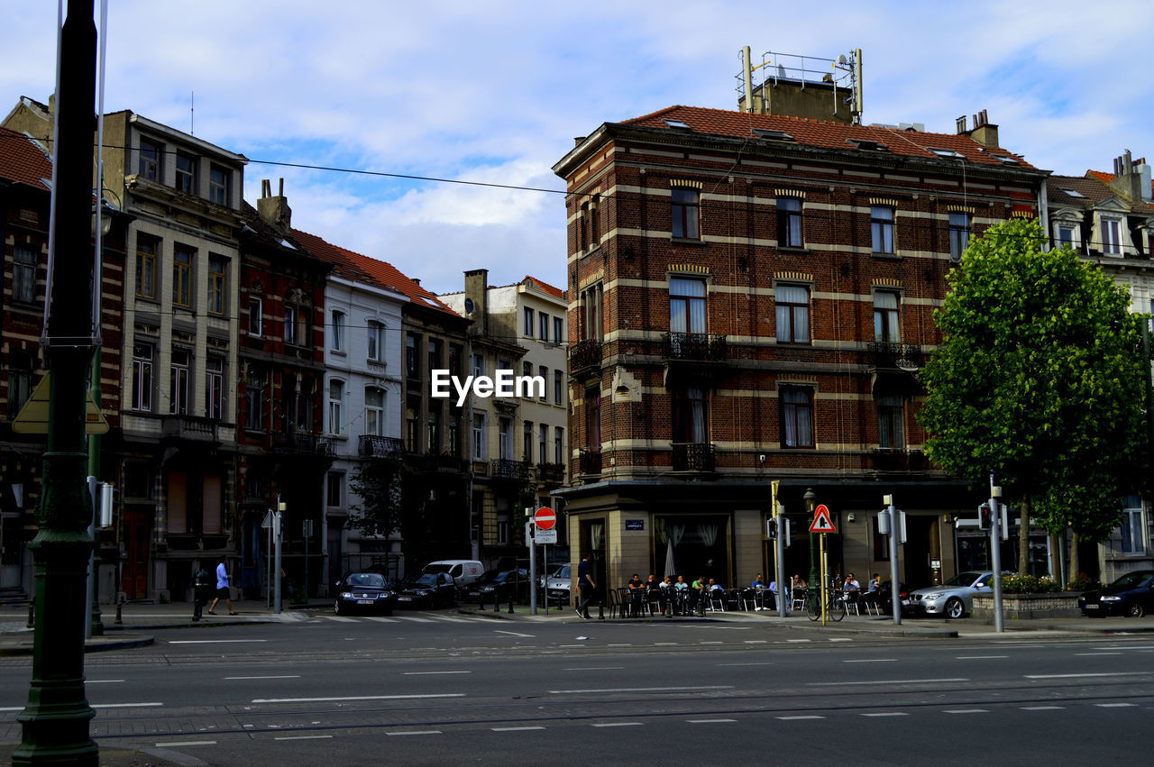 City street by buildings against sky