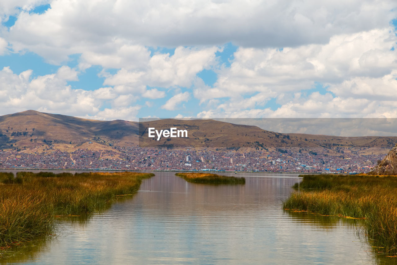 Scenic view of lake and mountains against sky