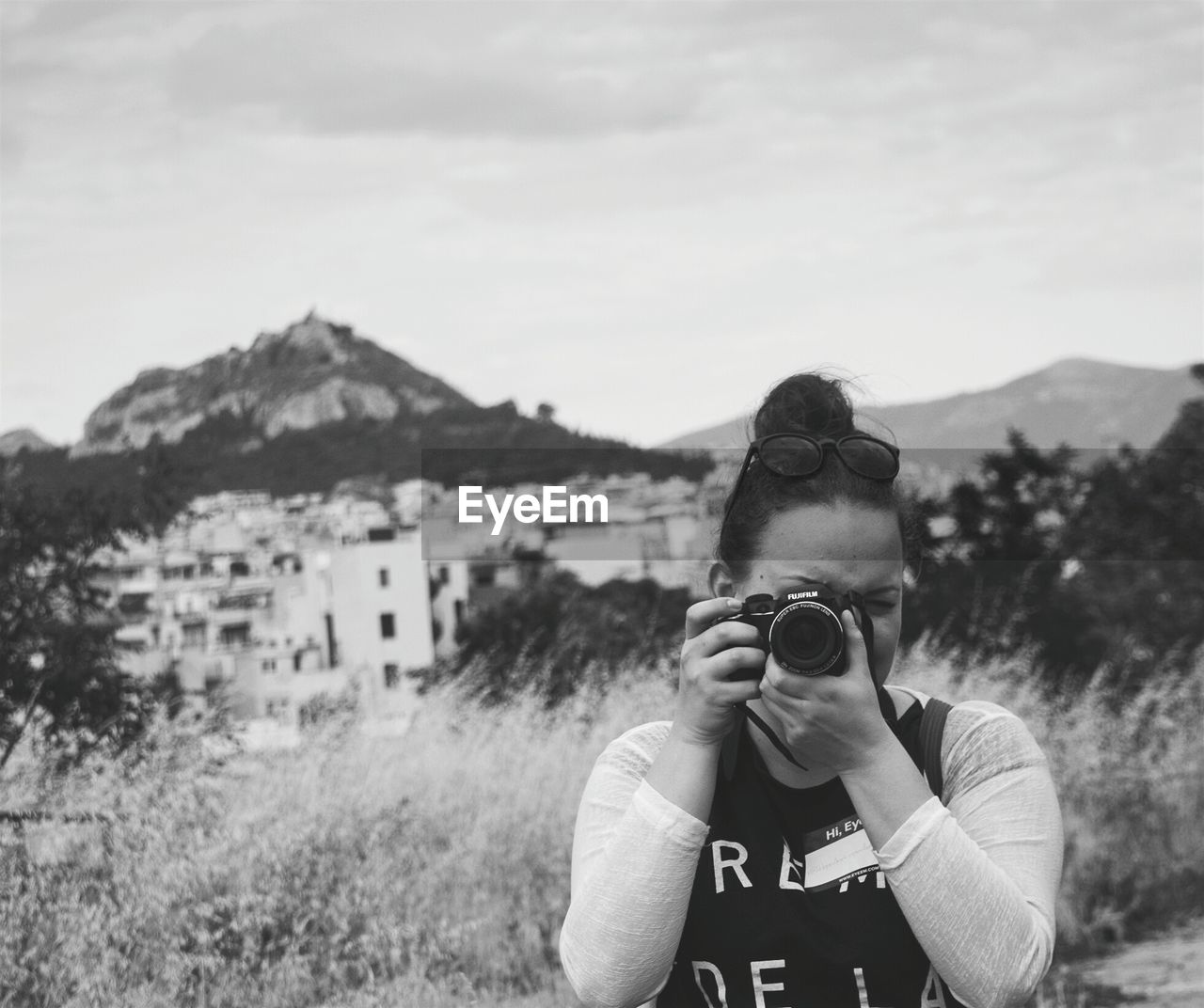 WOMAN STANDING ON MOUNTAIN LANDSCAPE