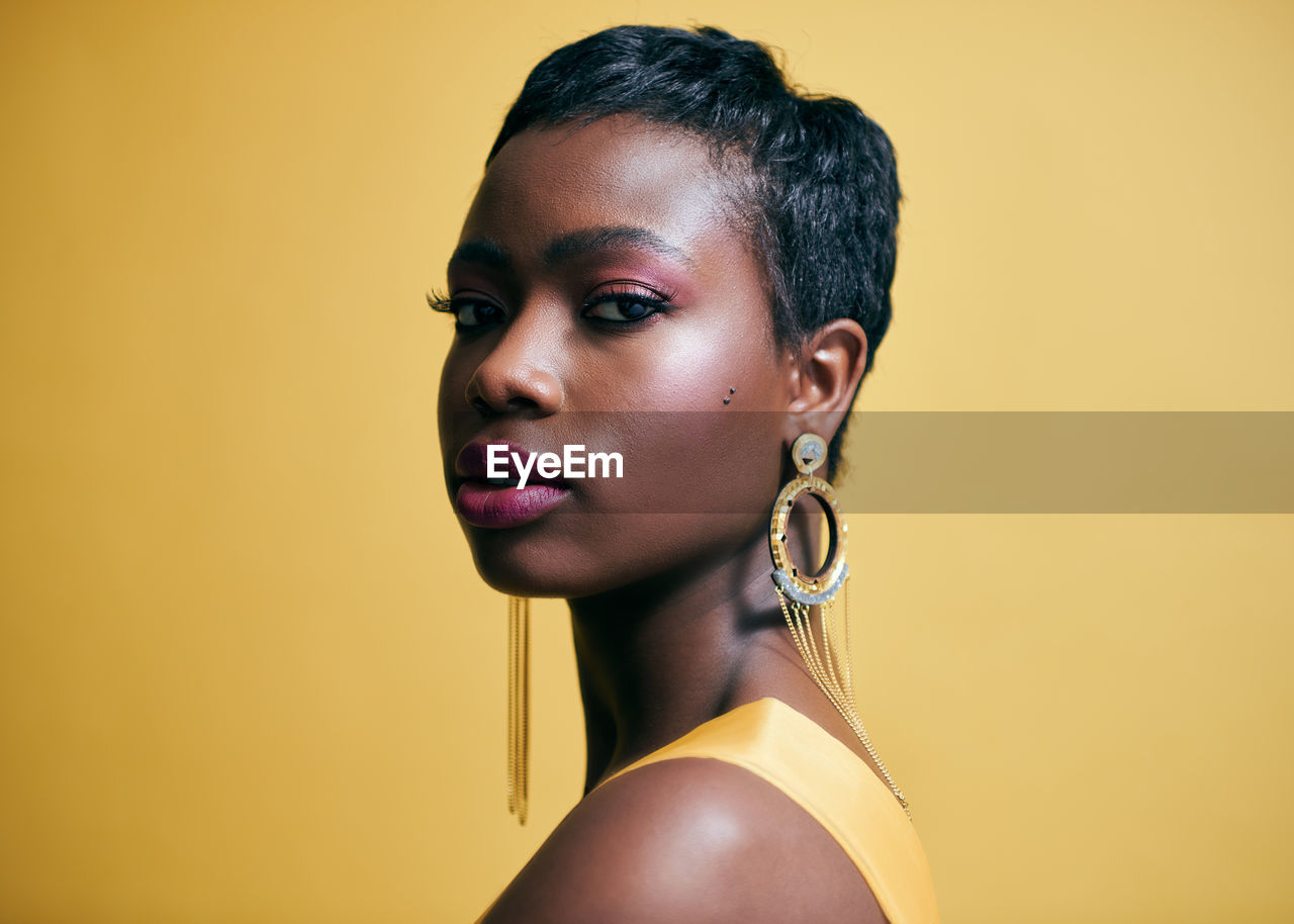 Portrait of beautiful  black woman against yellow background