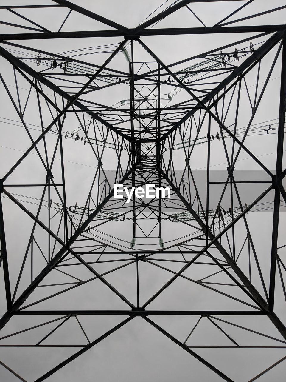 Low angle view of electricity pylon against sky