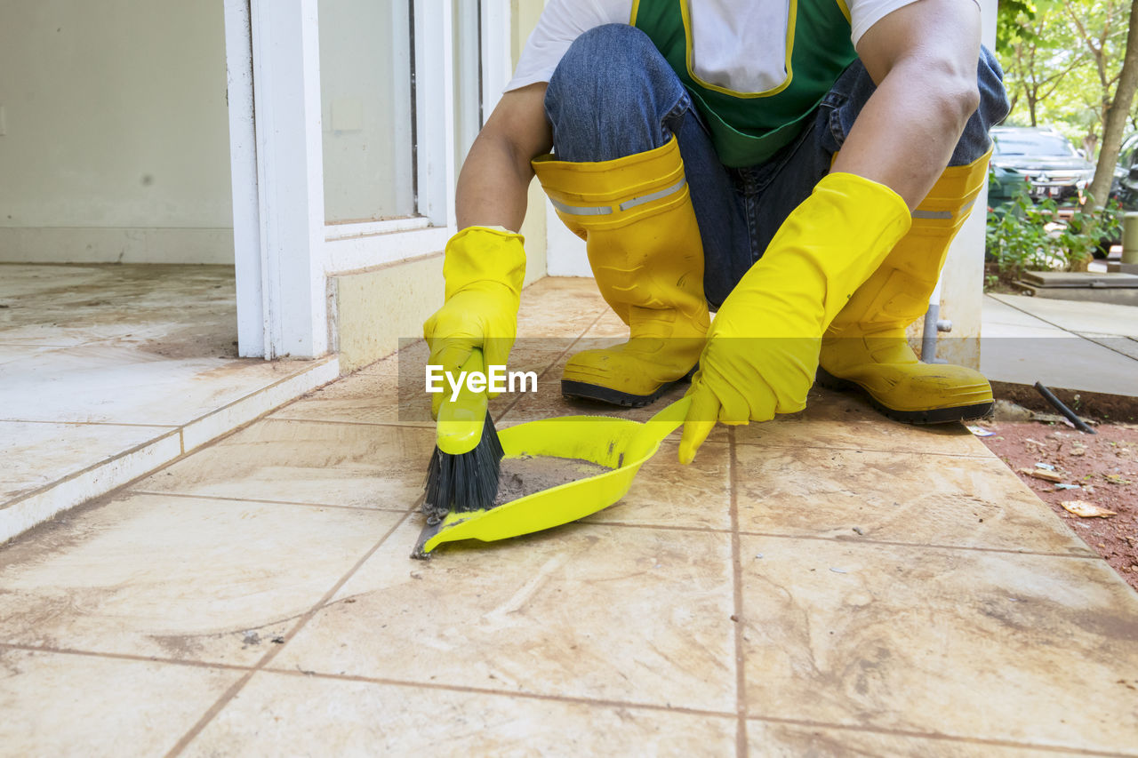 Low section of man working on tiled floor