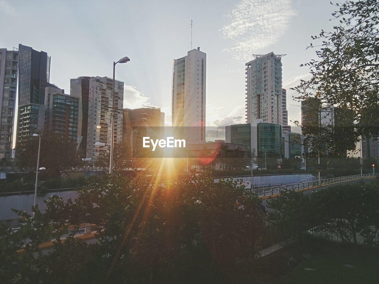 SKYSCRAPERS IN CITY AT SUNSET