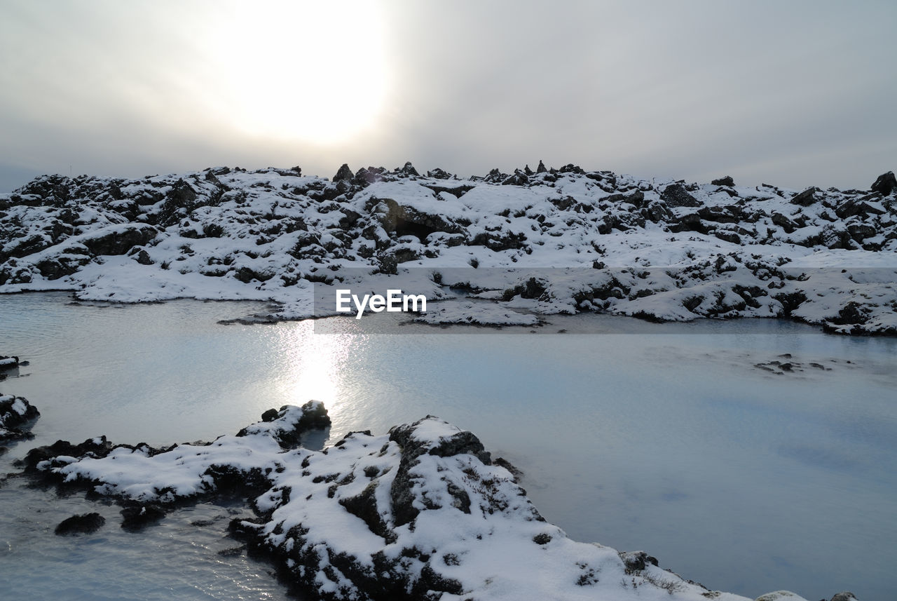 Scenic view of frozen lake against sky