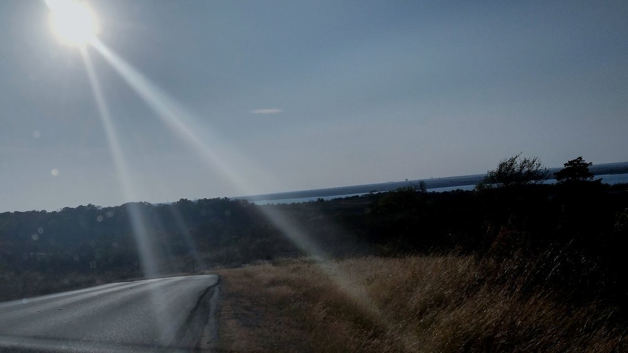 SUN SHINING THROUGH LANDSCAPE