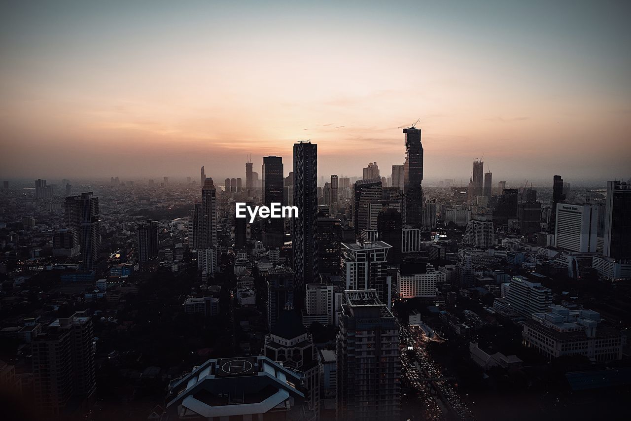 Aerial view of city buildings during sunset