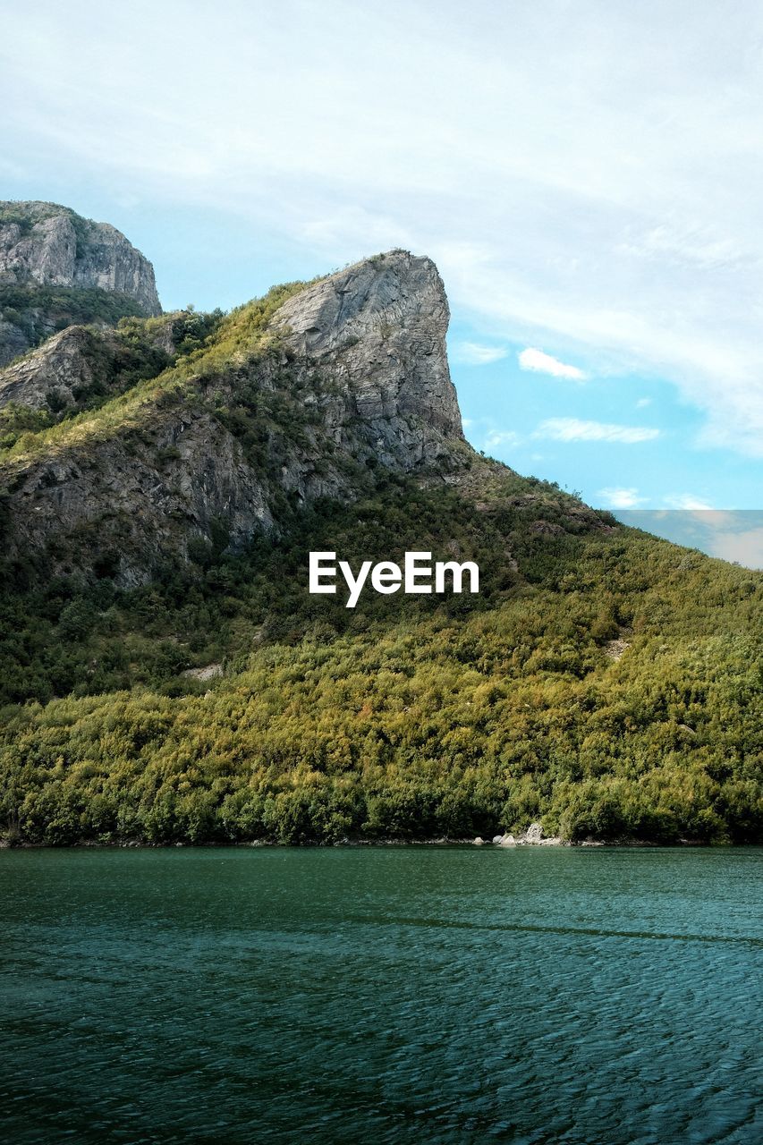 Scenic view of sea and mountains against sky