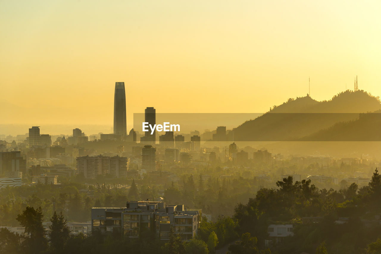 A silhouetted panoramic view of santiago de chile at sunset.