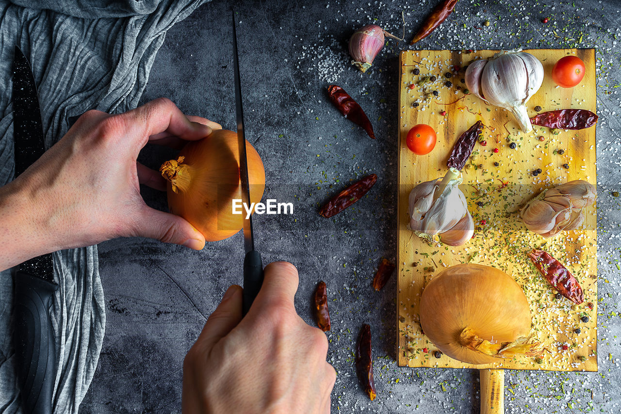 Cutting board with copy space with onions, lemons, garlic, chillies, tomatoes, blueberries, spices