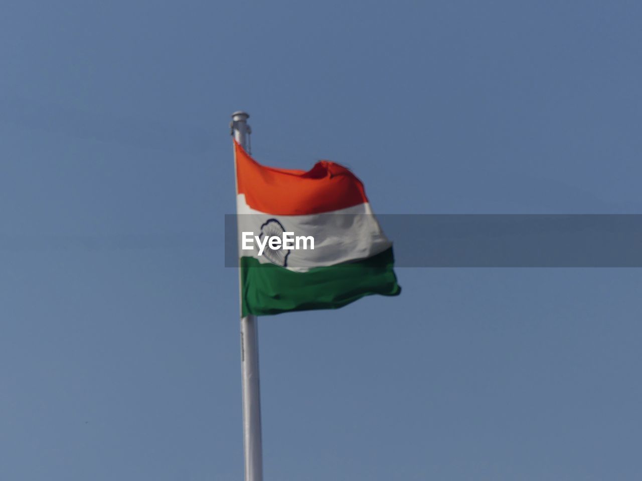 LOW ANGLE VIEW OF FLAGS AGAINST CLEAR SKY