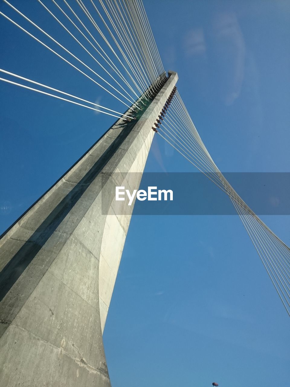 Low angle view of bridge against blue sky