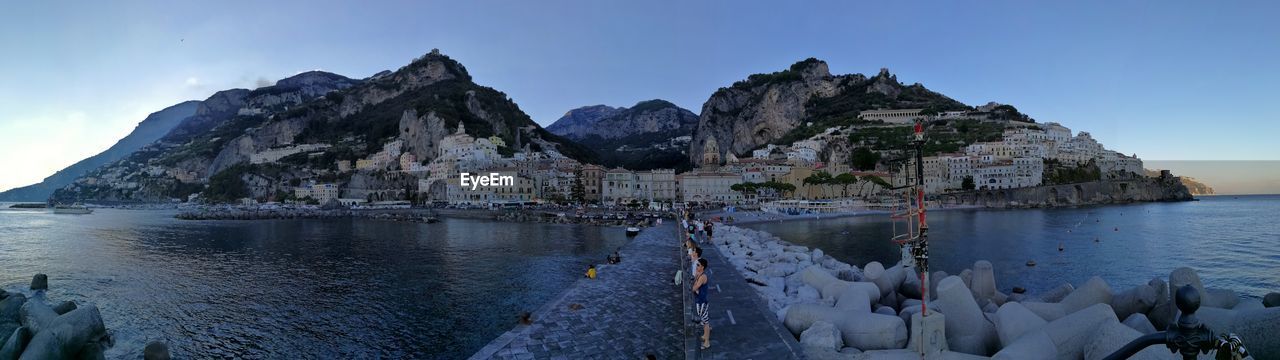 Panoramic view of sea and houses against sky