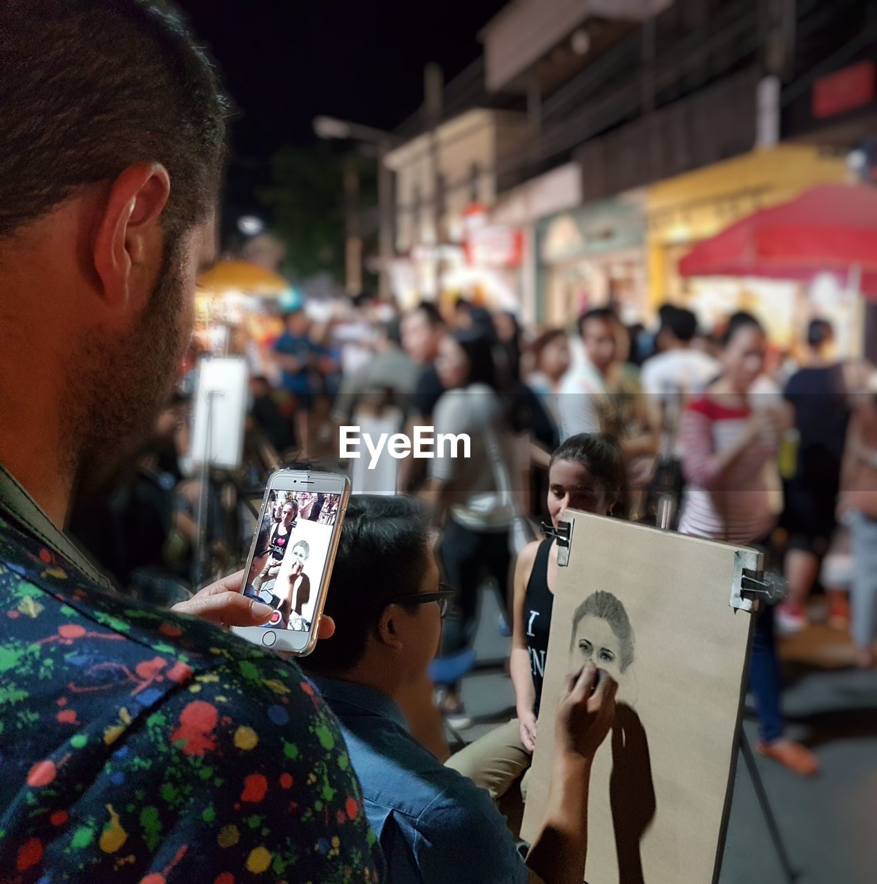 PEOPLE PHOTOGRAPHING ON STREET IN CITY AT NIGHT