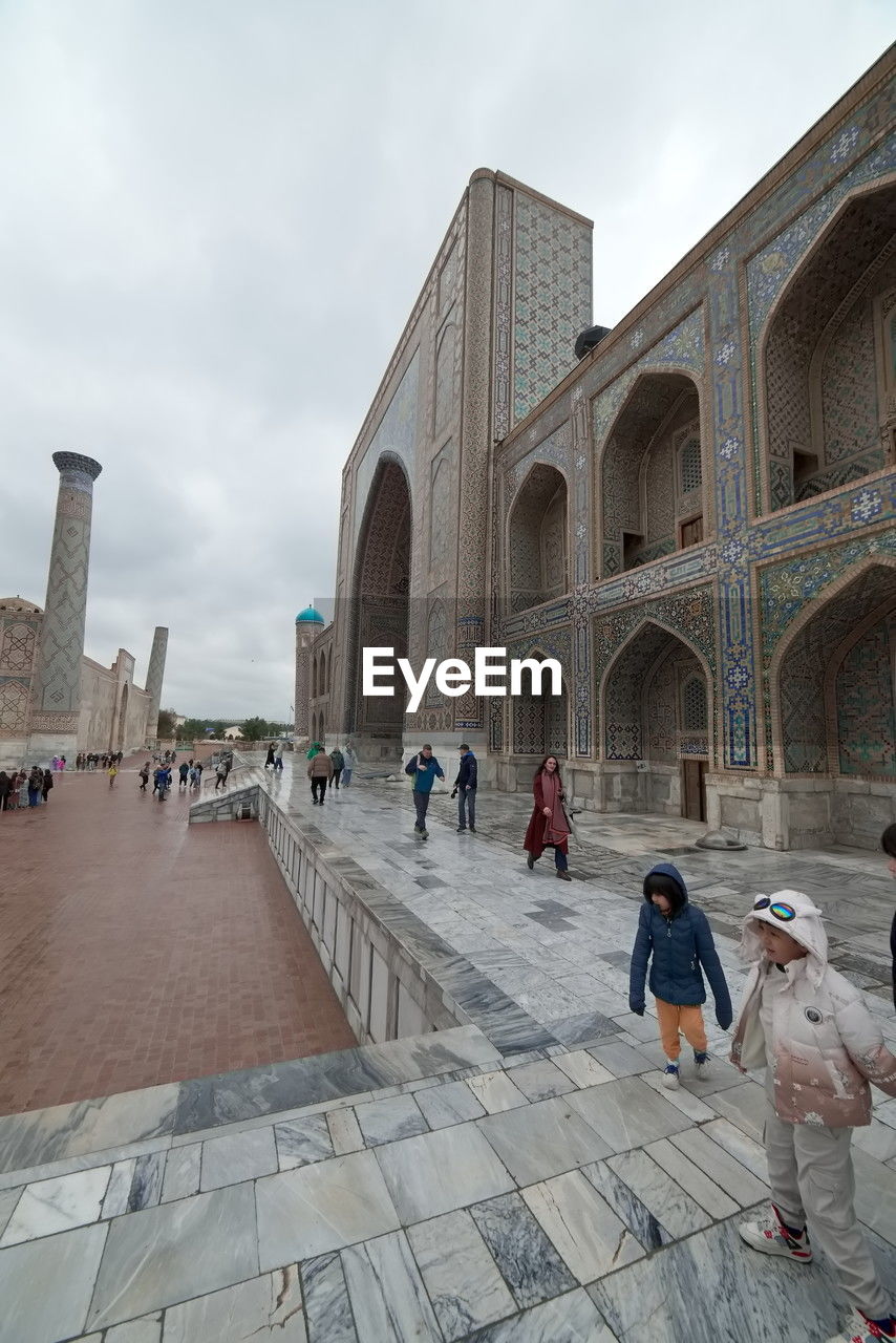 architecture, group of people, built structure, travel destinations, religion, building exterior, landmark, sky, adult, travel, city, history, the past, tourism, ancient history, crowd, arch, men, belief, place of worship, large group of people, nature, women, lifestyles, cloud, spirituality, building, outdoors, temple