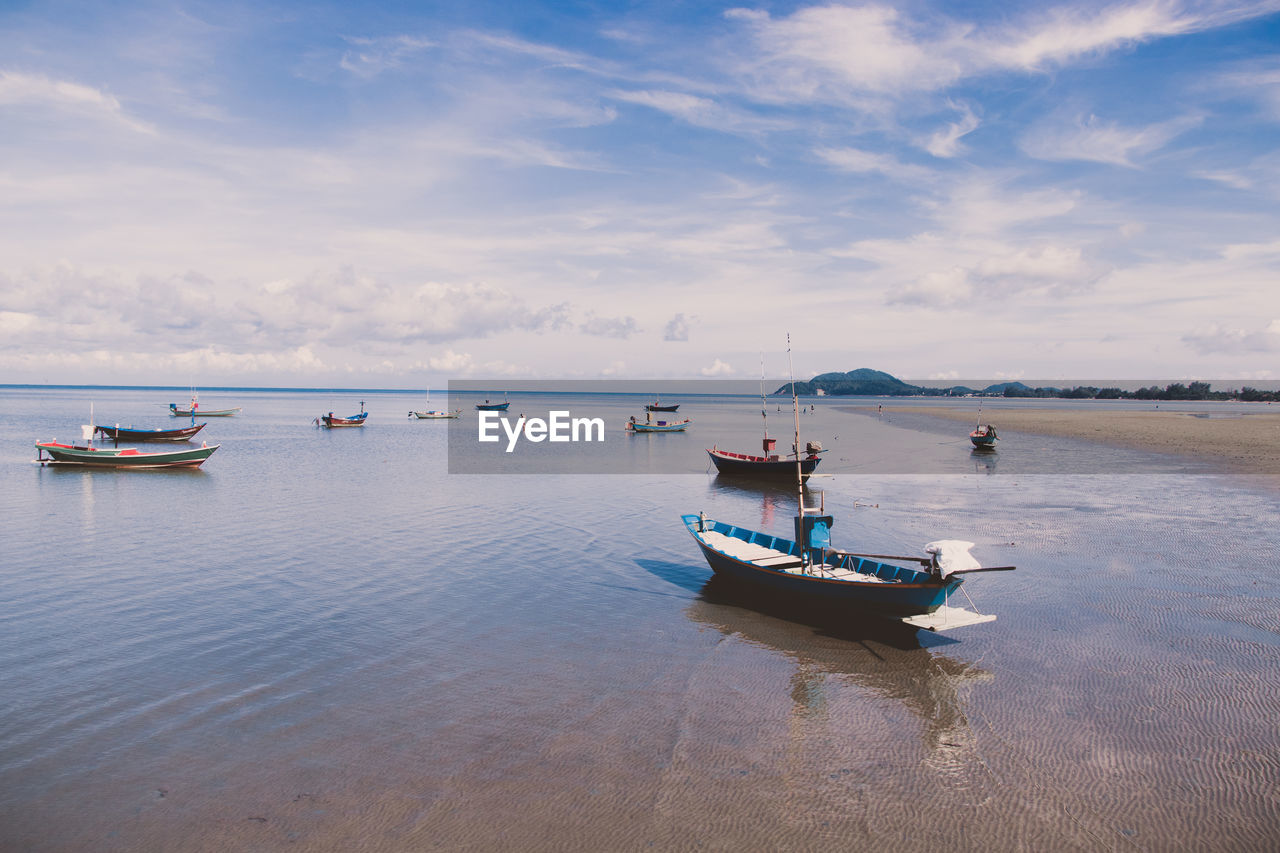 Boats in sea against sky