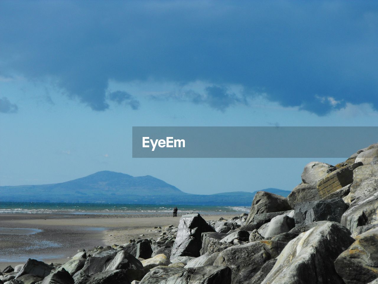 Scenic view of sea and mountains against sky