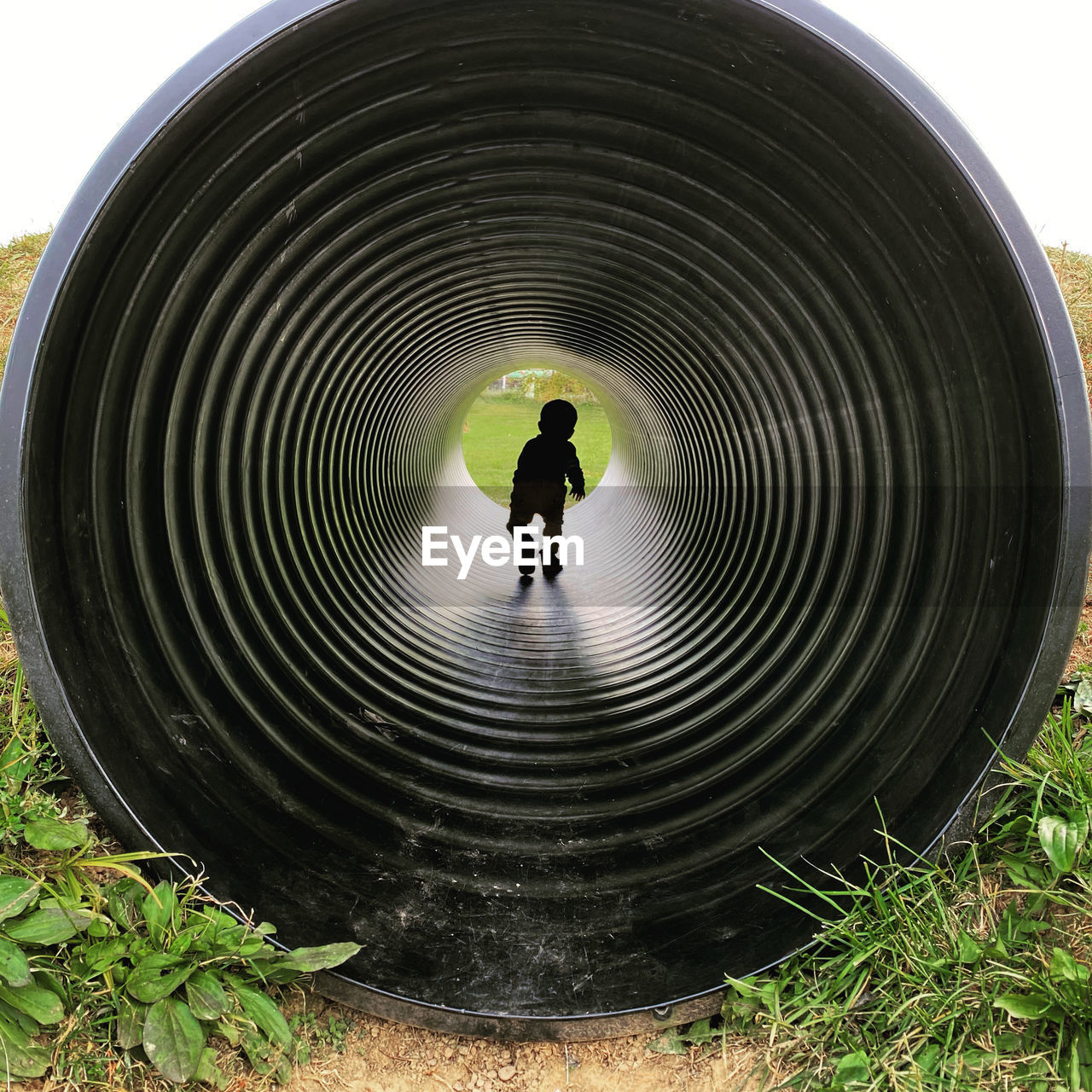 SILHOUETTE MAN STANDING IN TUNNEL