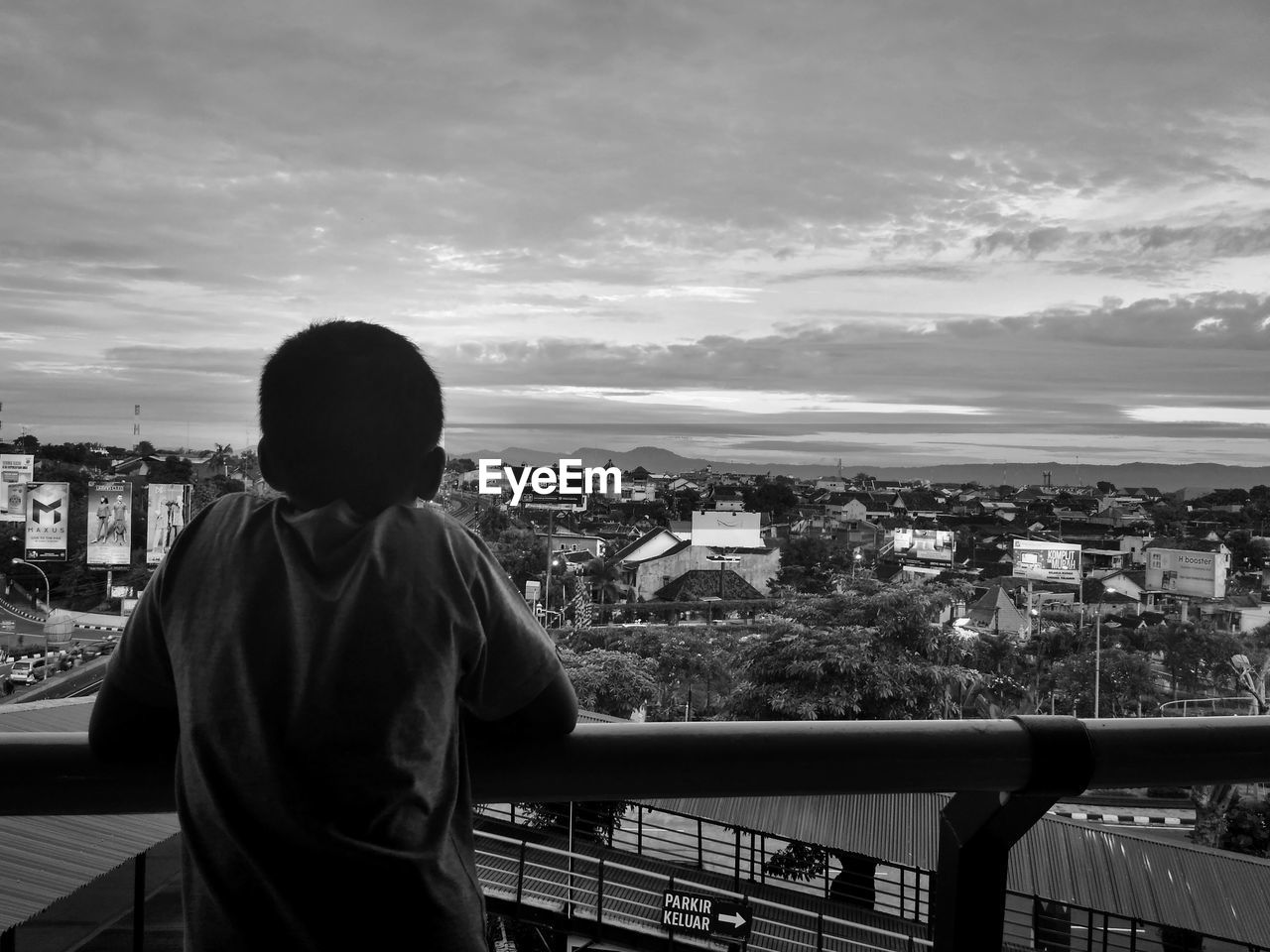 Rear view of boy looking at city from observation tower