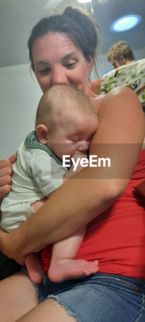 adult, two people, men, togetherness, emotion, love, women, person, indoors, positive emotion, young adult, bonding, human leg, human mouth, limb, lifestyles, casual clothing, lying down, relaxation, female, eyes closed, leisure activity, hand, human face, high angle view