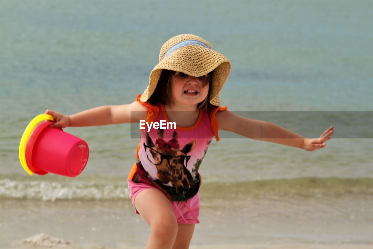 Cute scared running on shore at beach