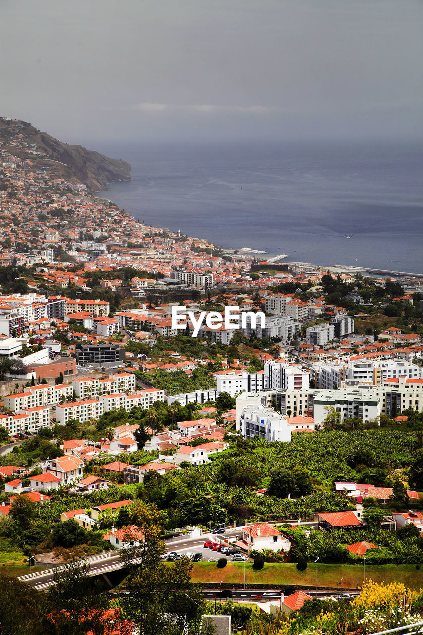 High angle view of residential buildings by sea