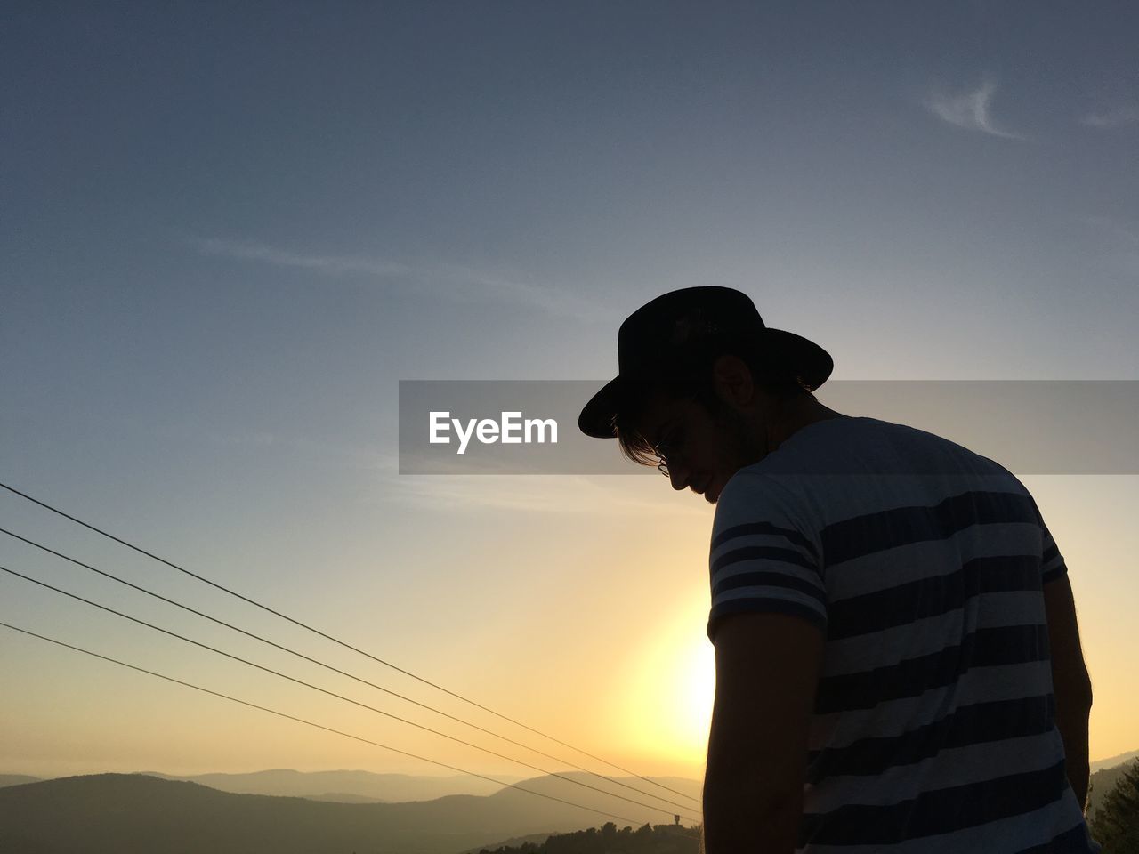 Man standing against sky during sunset