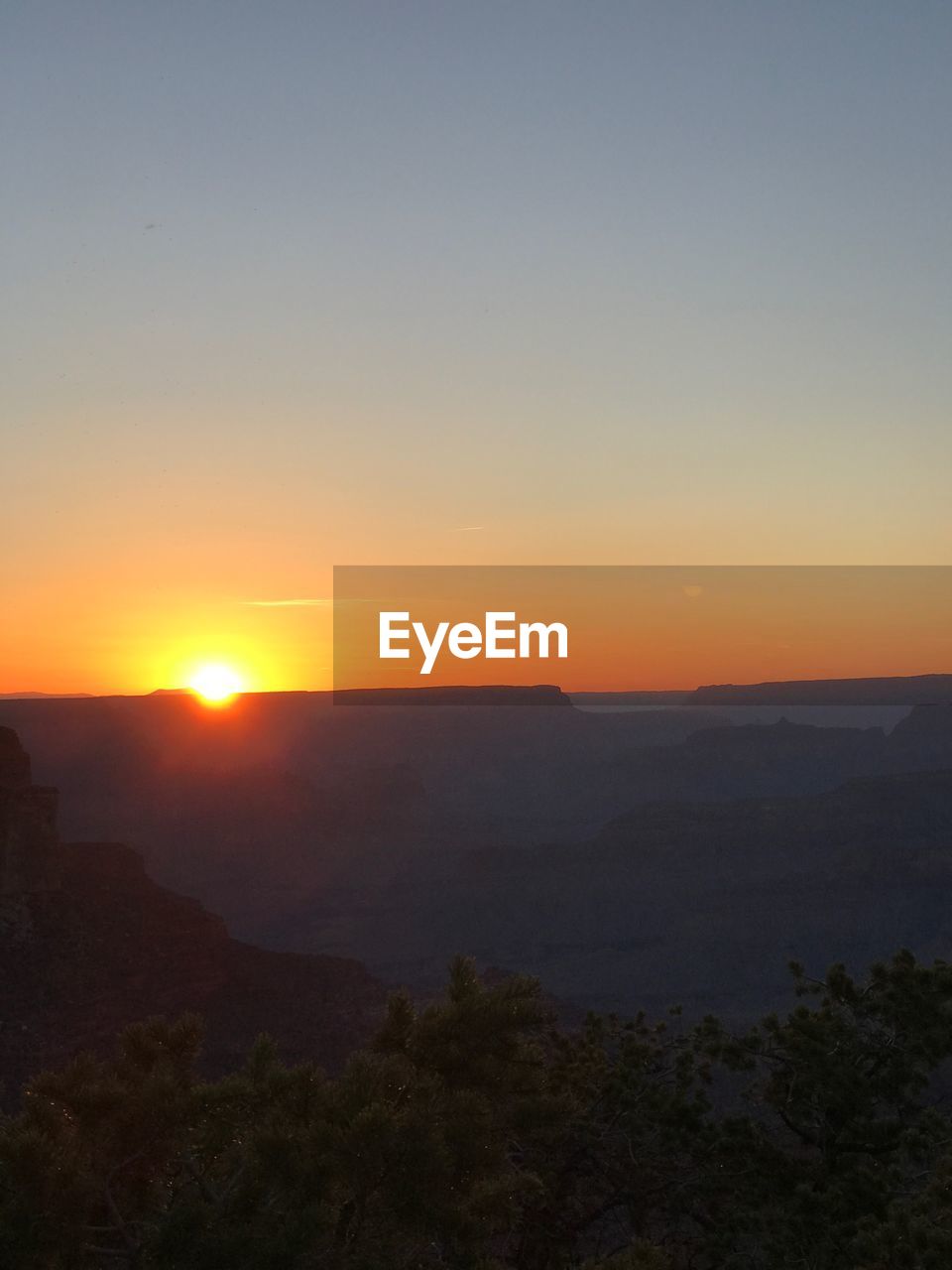 SCENIC VIEW OF SUNSET OVER MOUNTAINS