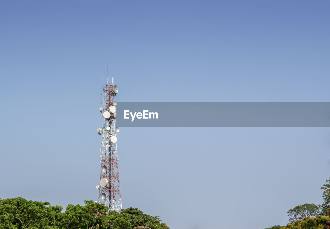low angle view of communications tower against clear blue sky